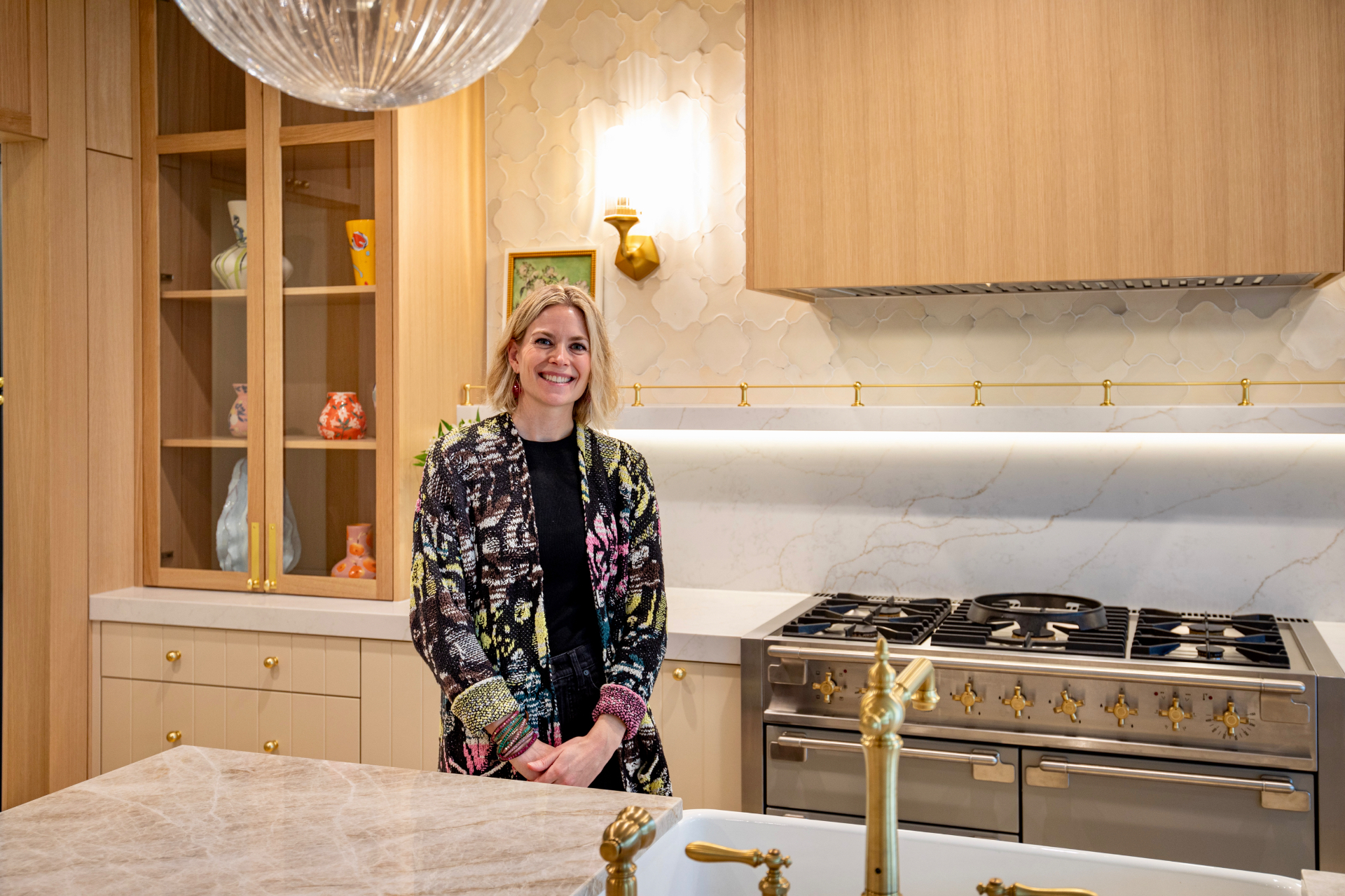 Brynn Dougherty, founder of Brynn Home Design, standing in a finished Edmonds kitchen